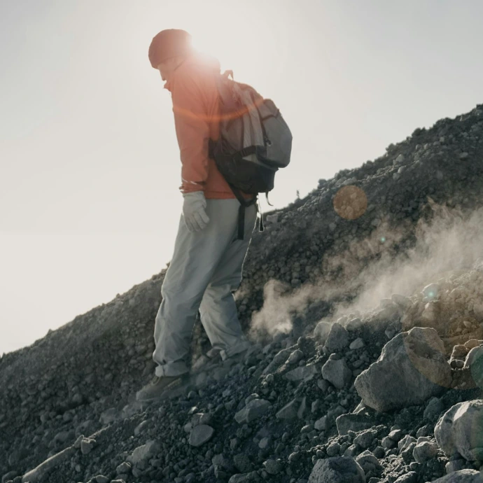 man walking on rock mountain